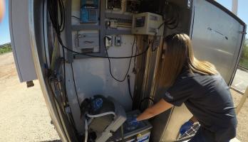 ASU PhD candidate Erin M. Driver examines a water sampling station