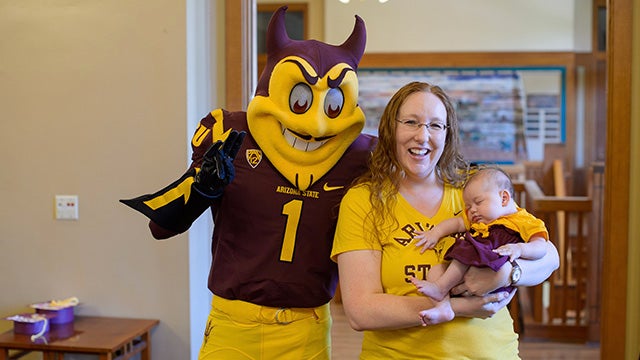 Sparky posing with a young family