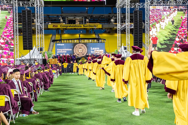 A group of Goldren Reunion graduates walking in undergraduate commencement. 