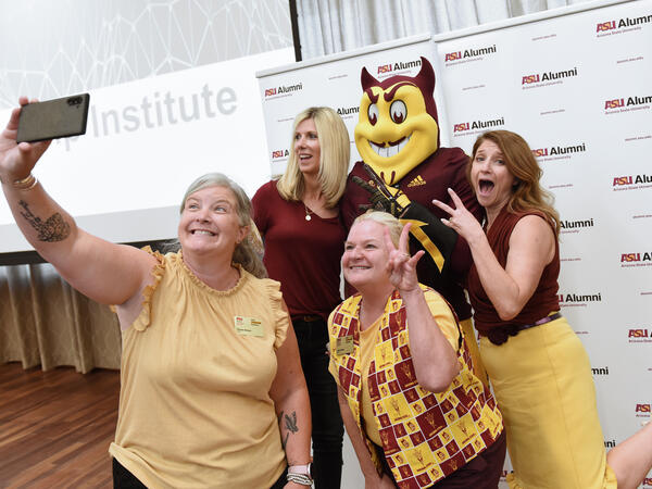 A group of ALI members take a photo with Sparky