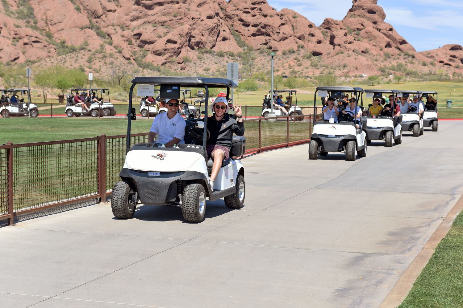 People riding in golf carts.